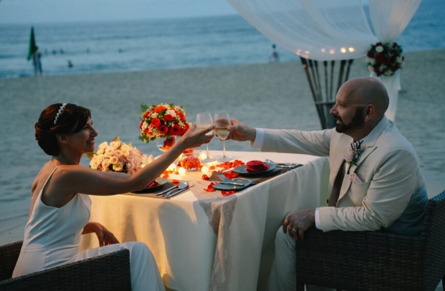 Couple toasting at a romantic beach dinner